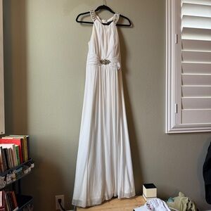 formal floor length white gown with gold detail